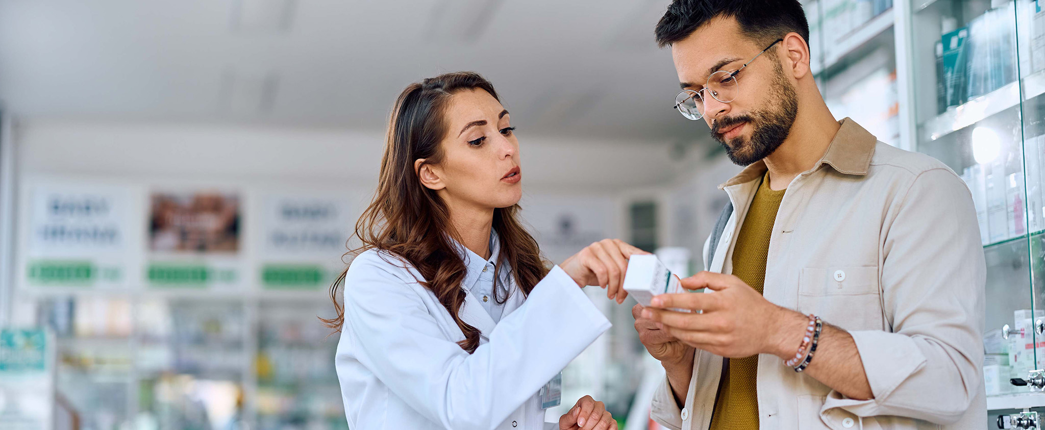 pharmacist explaining about medication to a patient at the pharmacy
