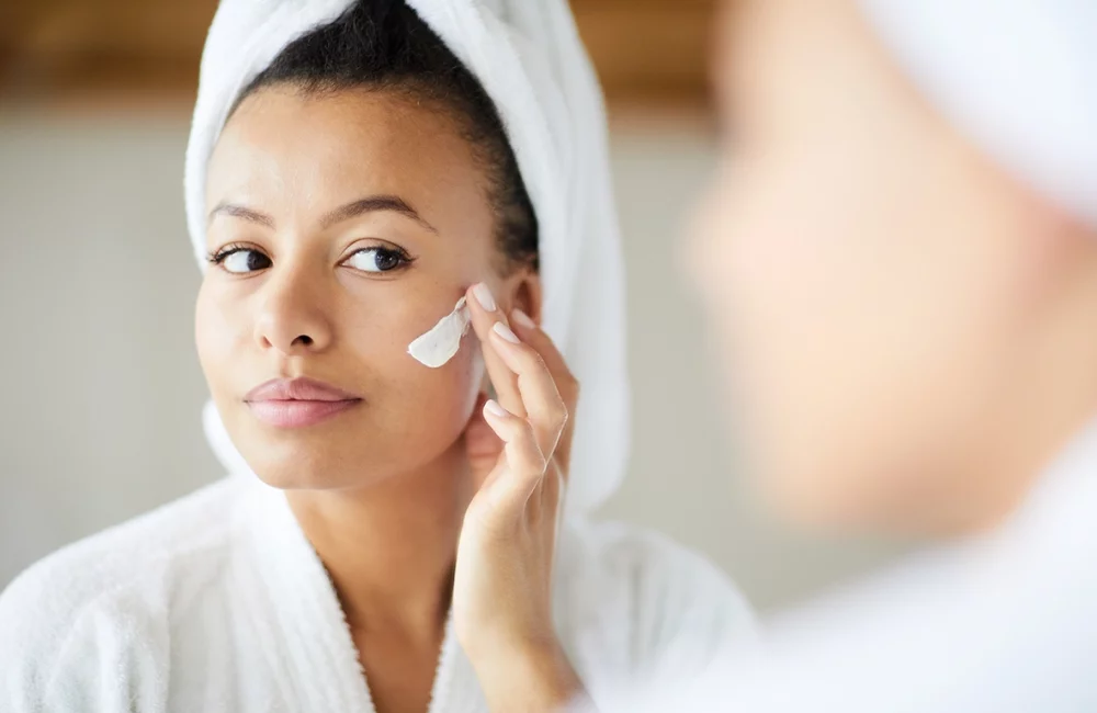 woman applying facial cream